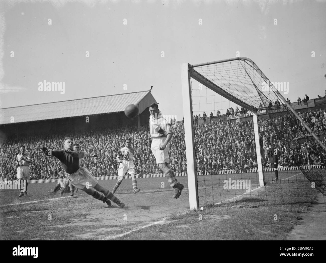 Dulwich Hamlet vs. Erith and Belvedere - London Senior Cup final - Erith and Belvedere's goalkeeper George Barron diverts the ball behind. Played at Millwall's ground in New Cross - 13/05/39 Goal mouth action , the ball goes wide . 1937 Stock Photo