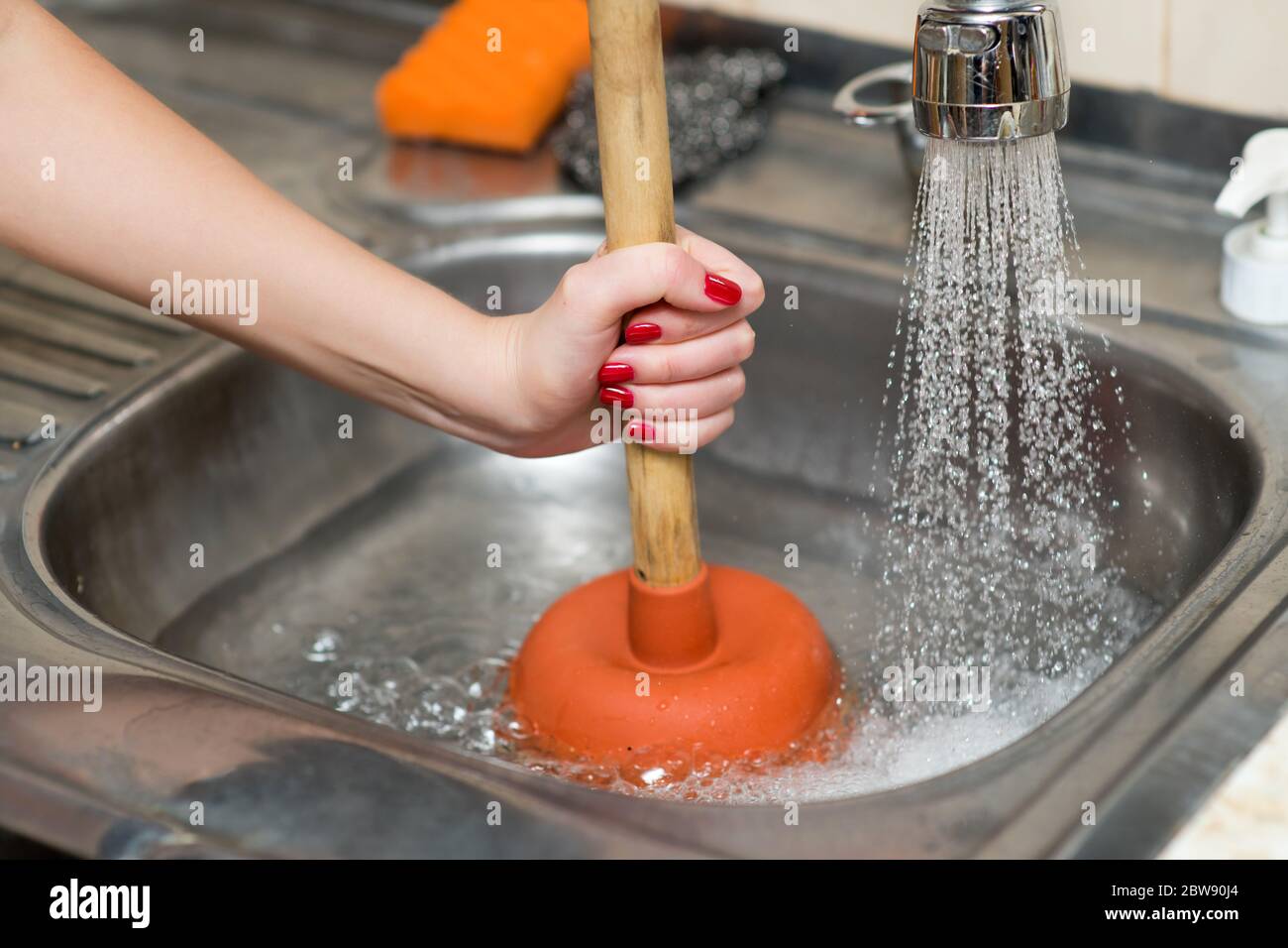 Sink plunger woman hi-res stock photography and images - Alamy