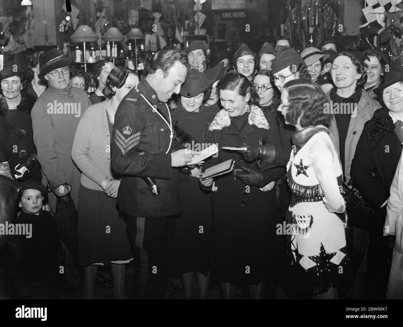 Vocalist Billy Scott - Coomber signing autographs at the Lewisham Hippodrome . 1939 Stock Photo