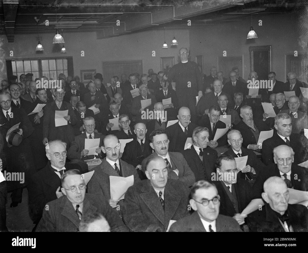 Dartford veterans club extension opening . The men stand up singing . 1939 . Stock Photo