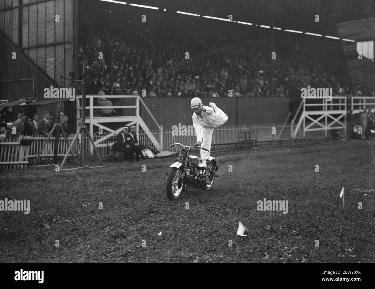 The Gravesend and District Motor Cycle Gymkhana in Kent . World champion Jim Hayhurst performs stunts on his bike in front of spectators . 19 June 1939 Stock Photo