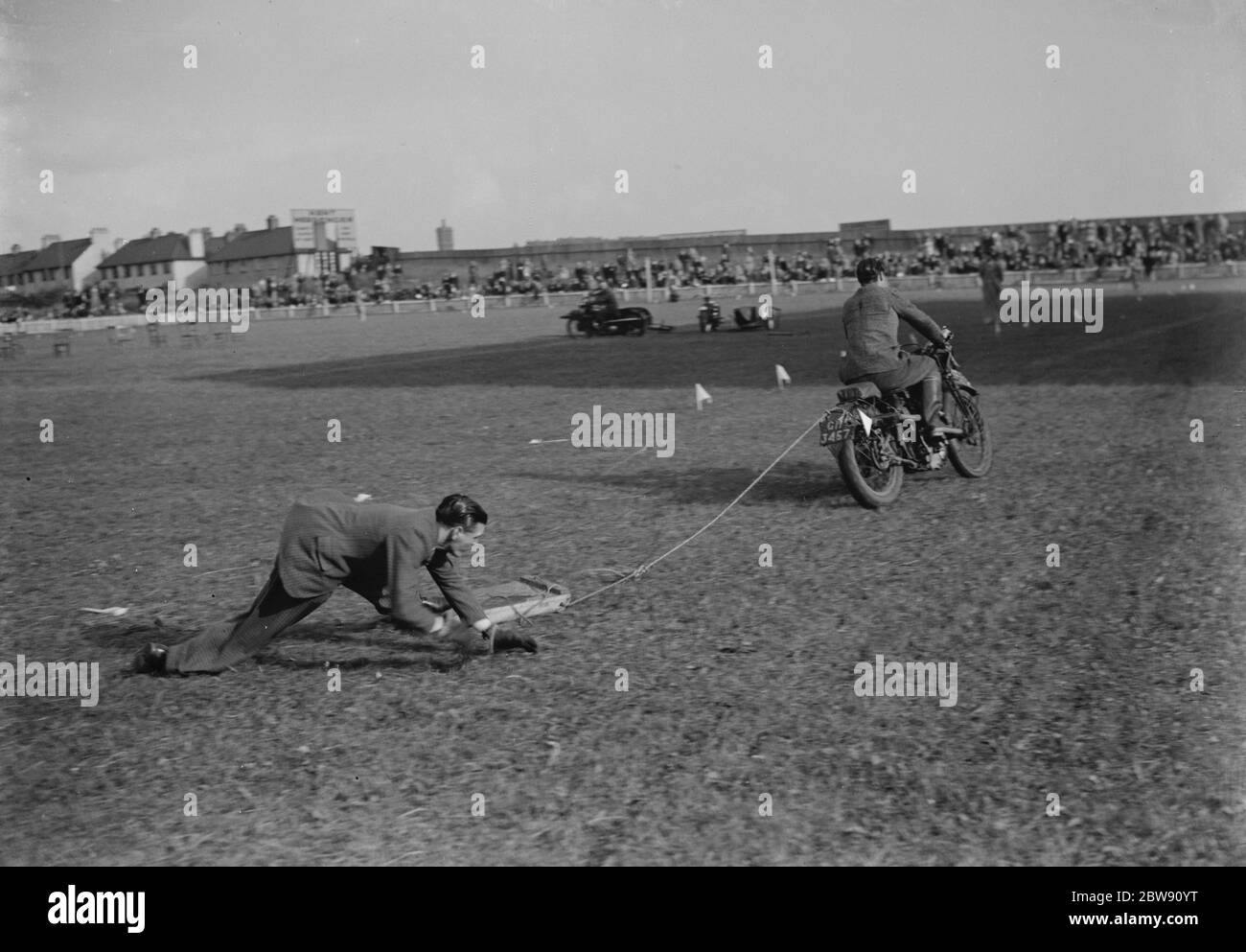 The Gravesend and District Motor Cycle Gymkhana in Kent . This race involves the motorbikes towing someone on a wooden plank around the track . 19 June 1939 Stock Photo