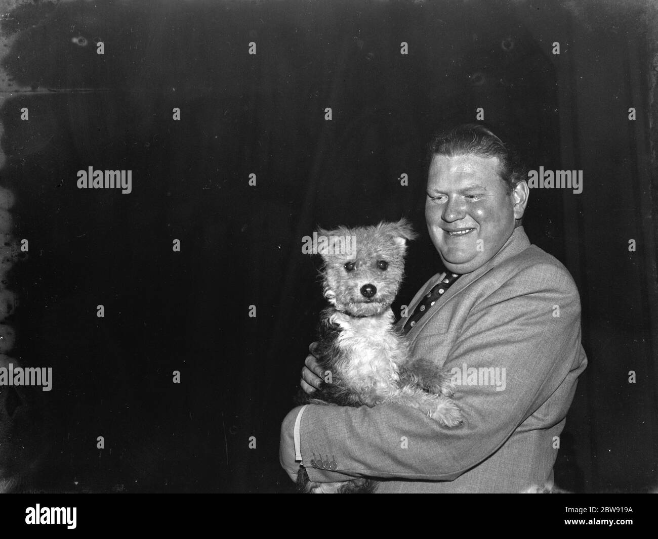 Bryan Michie , a leading show business impresario , who specialized in finding juvenile talent which he would feature in one of his variety shows . Here he is with his canine ' discoveries ' . 1939 Stock Photo
