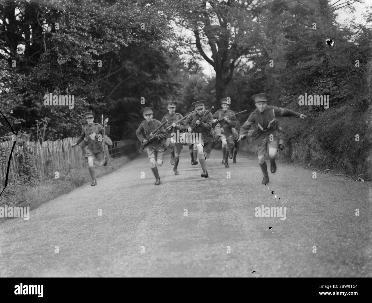 Boys from St Dunstan ' s School Cadets performing field drills armed with Lee Enfield No.I Mk.III rifles . 1939 . Stock Photo