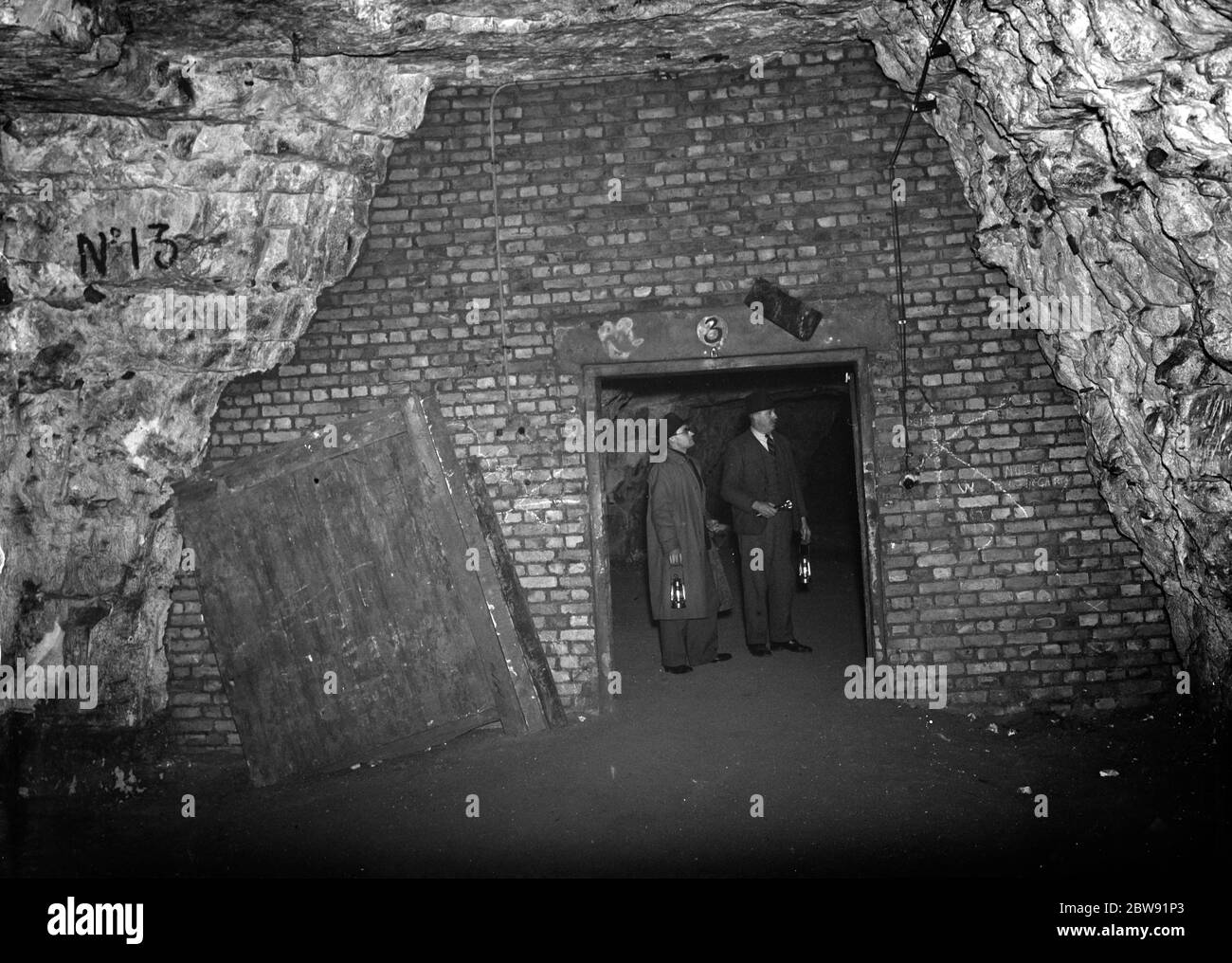 Men inside the Chislehurst caves at the explosive stores . 1938 Stock Photo