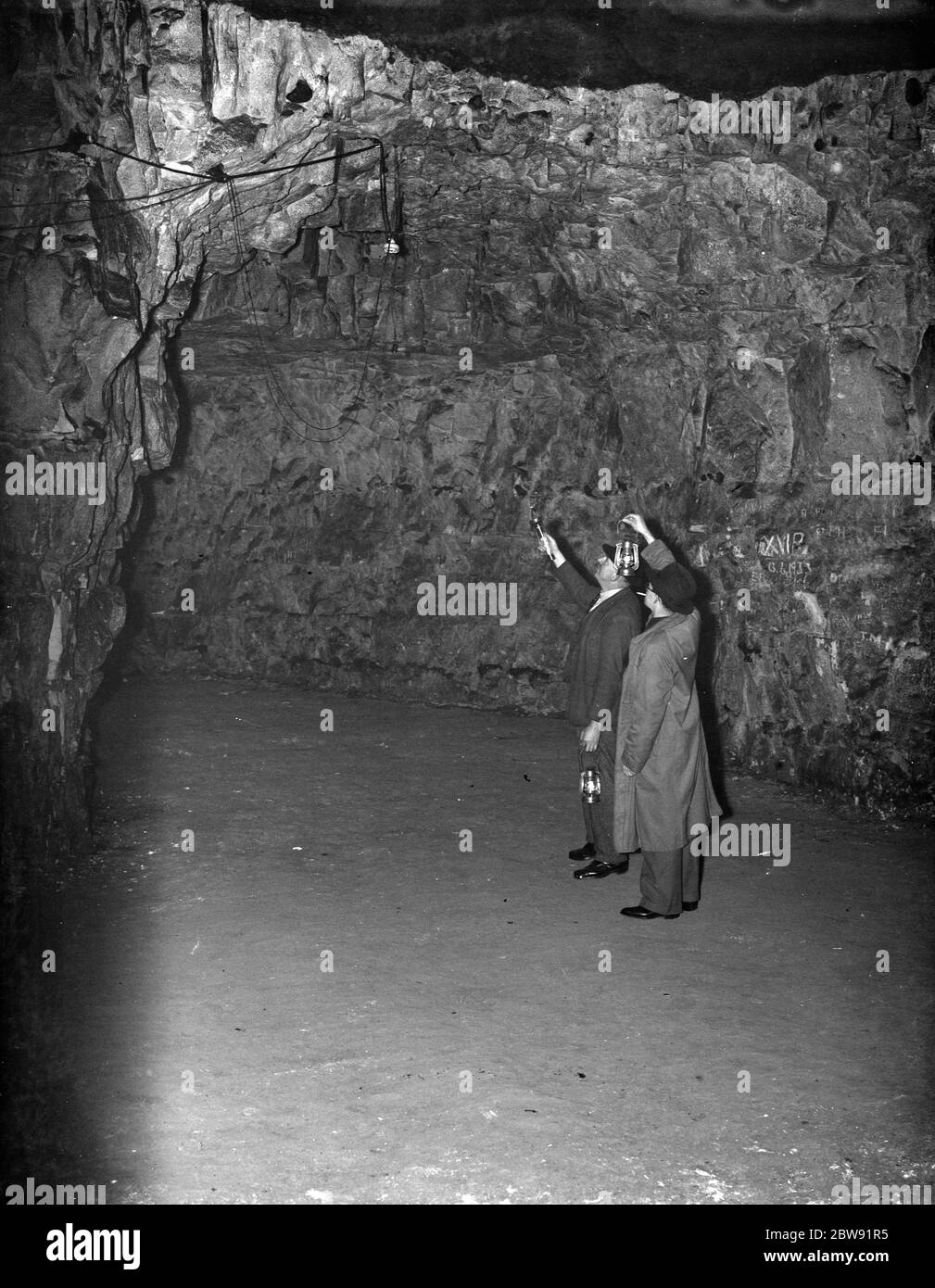 Men inside the Chislehurst caves at the explosive stores . 1938 Stock Photo