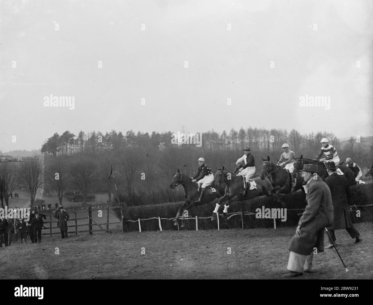 Horses jumping the fences at the R A Woolwich point to point . 1936 Stock Photo
