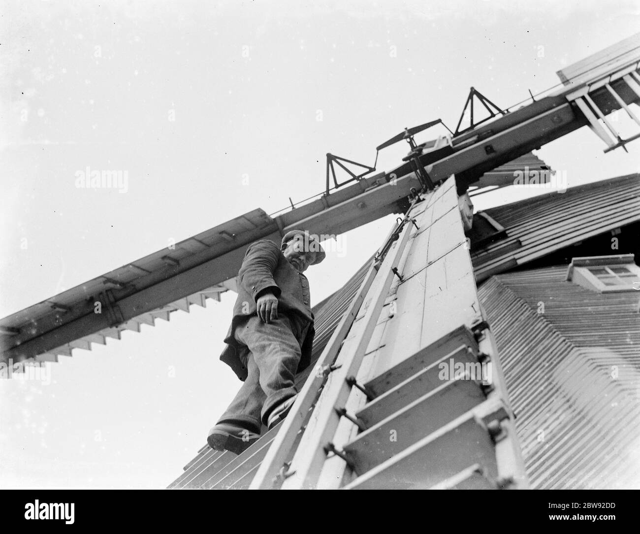 A man up on a windmill . 1939 Stock Photo