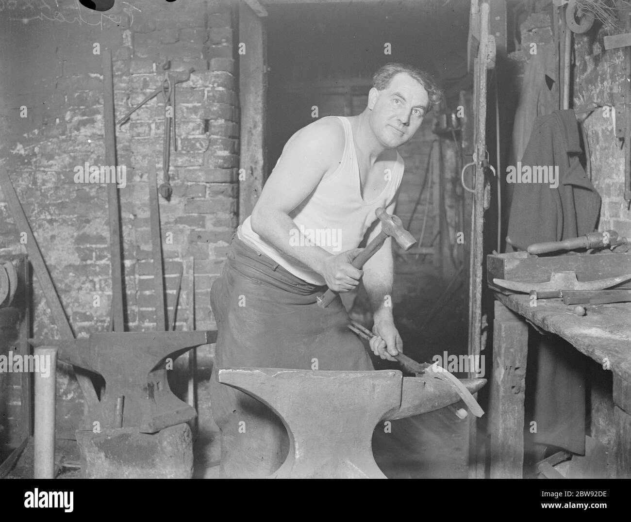 Doug Holland the blacksmith at work . 1939 Stock Photo