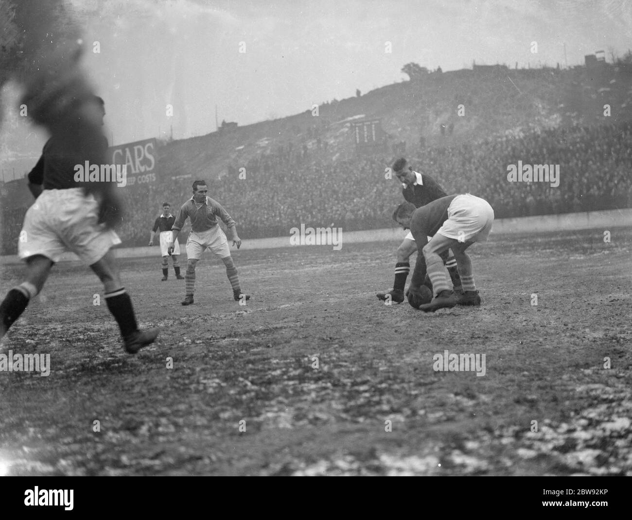 Action on the football pitch . The goalkeeper picks up the ball . 1939 Stock Photo