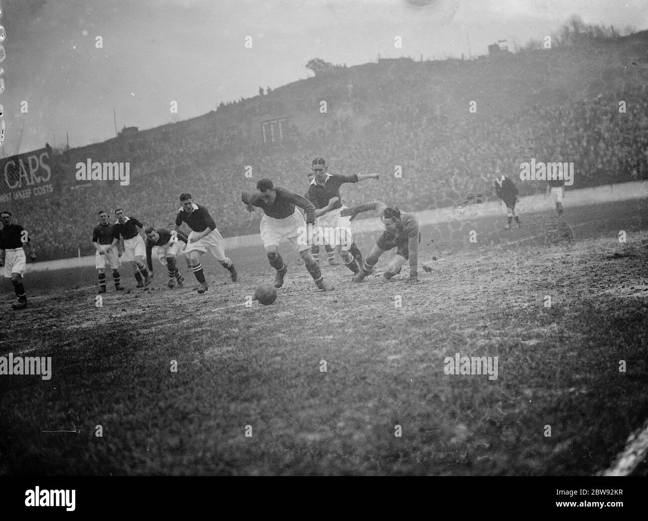Action on the football pitch . Players compete for the ball . 1939 Stock Photo