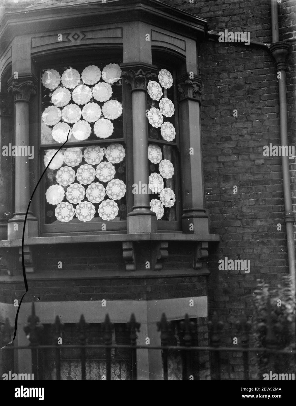 A window made splinter proof using cake mats . 1939 Stock Photo