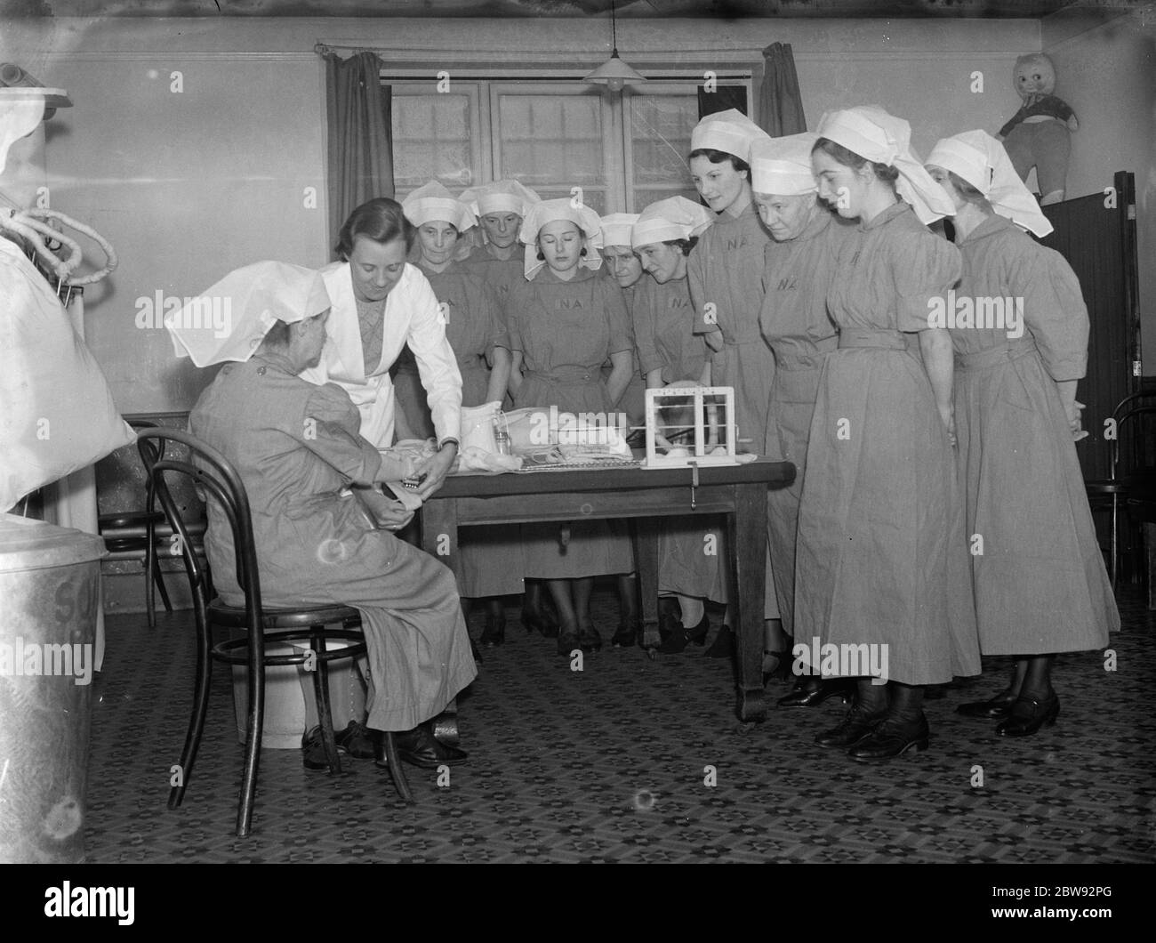 Nurses from the Nursing Auxiliaries receive instruction at the Kensington Convent in London . 1939 Stock Photo