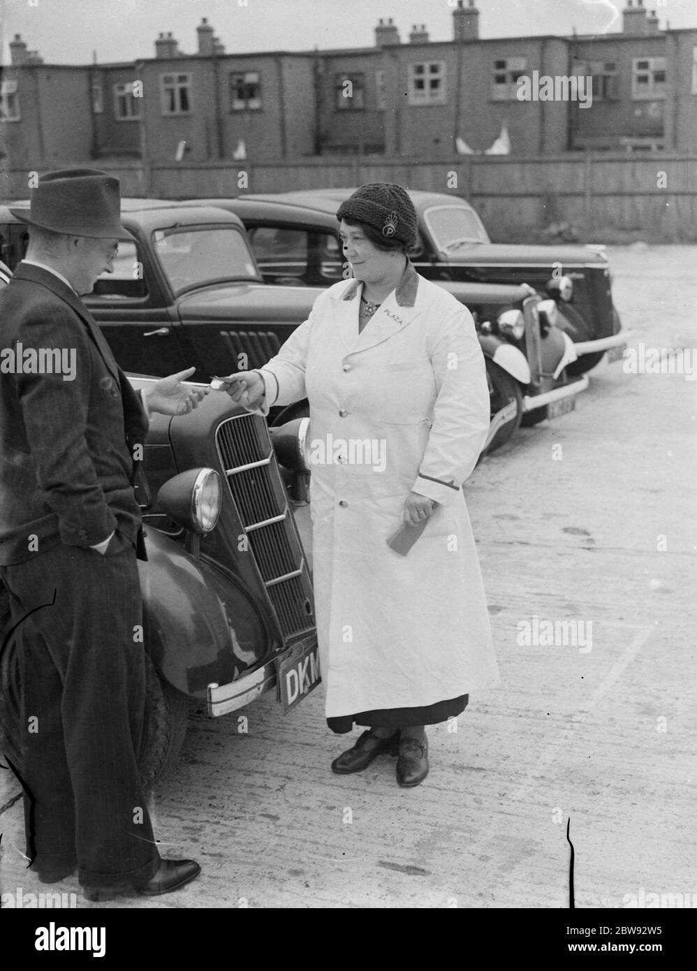 Mrs E W Haffenden takes over as a car park attendant at the cinema from her husband . Here she is issuing a ticket . 1939 Stock Photo
