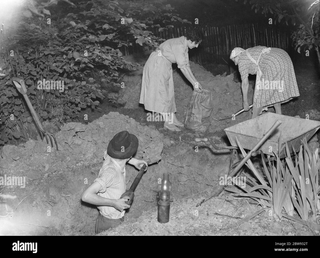 Mrs Harris and others digging air raid shelters . 1939 Stock Photo