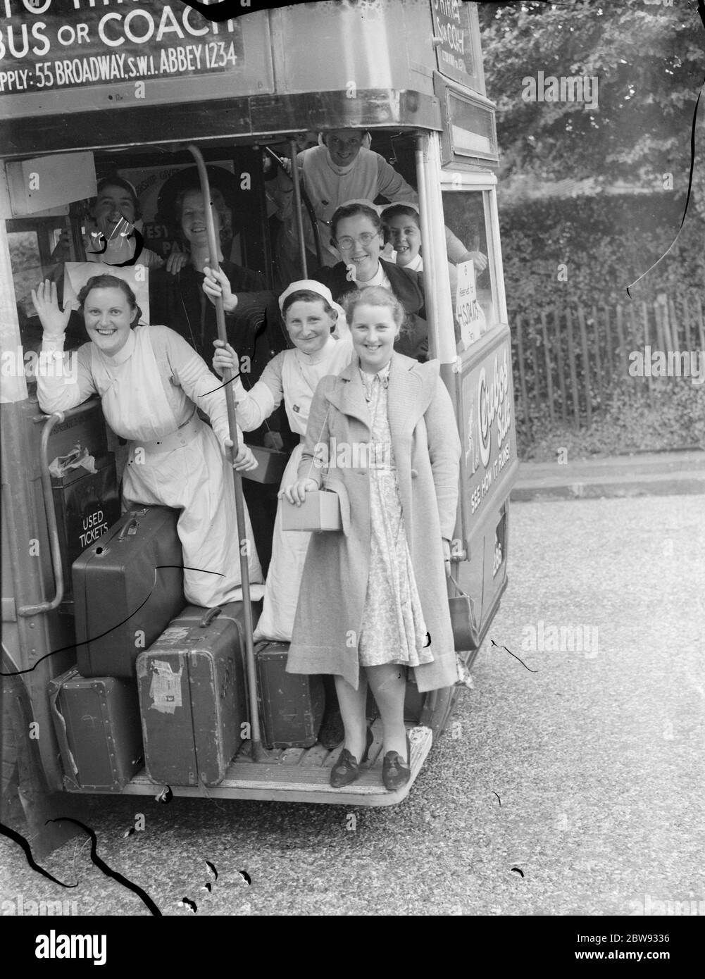 In response to the dangers of war the British government launched a scheme to evacuate the children and other civilians from major urban centers to private housing in more rural areas . Photo shows nurses on evacuation . 1939 Stock Photo