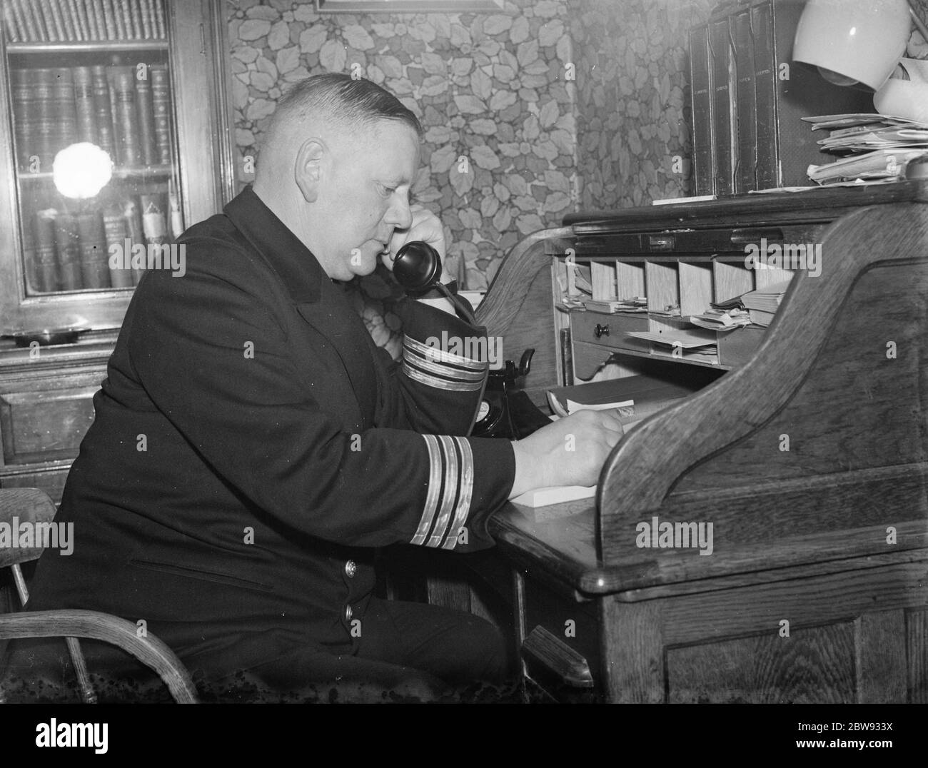 Thames pilots at Gravesend , Kent , who help ships navigate through the congested waters of the harbor. Ruler of pilots , Mr L E Owen , at the telephone desk . 1939 Stock Photo