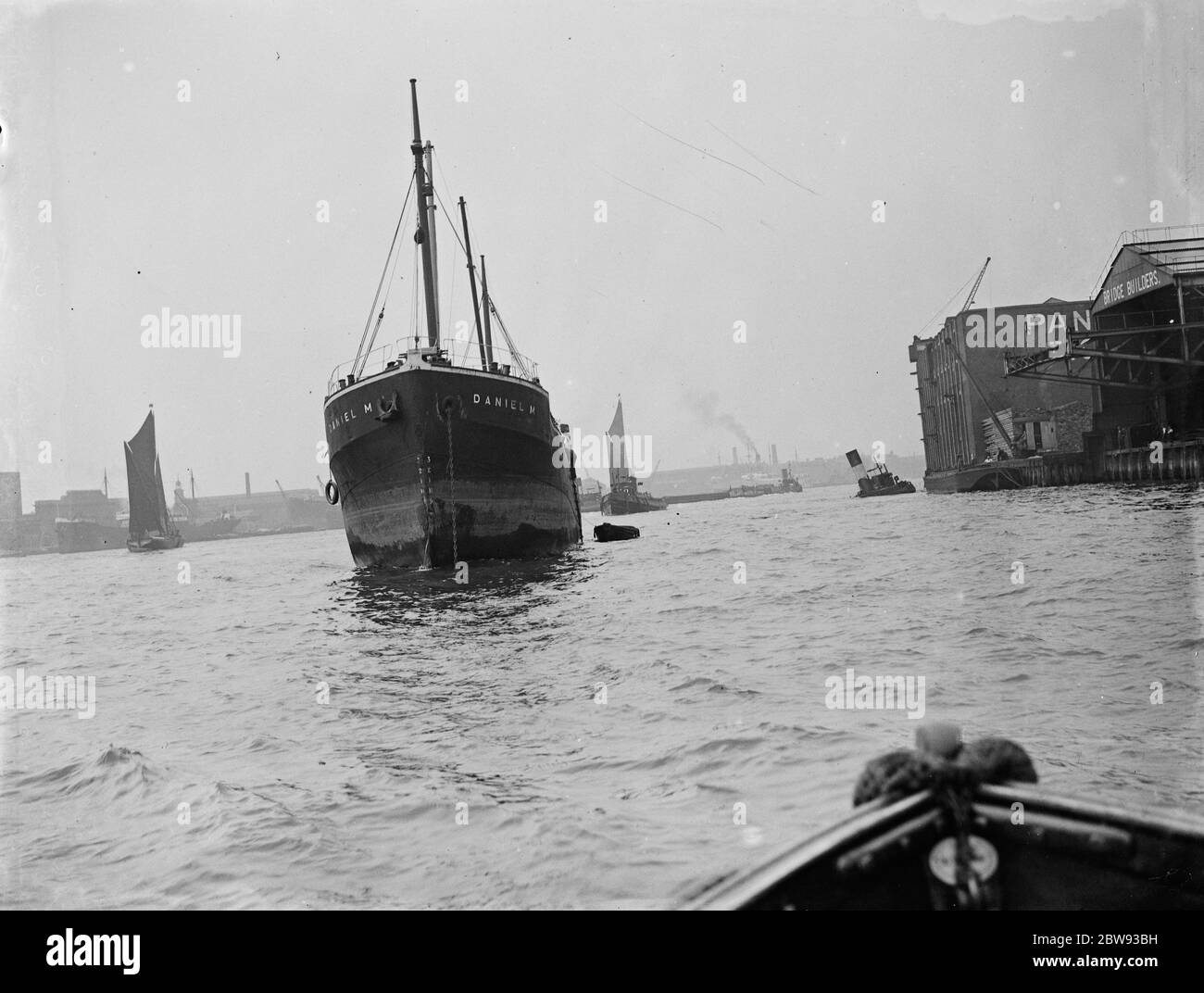 The prow of ' Daniel ' , a merchant ship , following a collision with the tug ' , Gusty ' , on the River Thames at Greenwich , London . The partially sunk tug can be seen to the right of the picture . 1939 Stock Photo