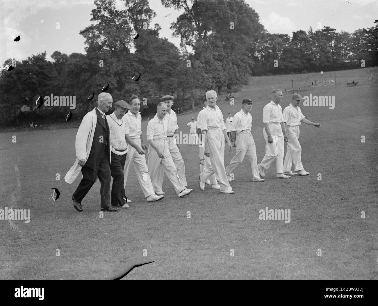 Cricket scenes in Wilmington , Kent . Veteran cricketers walk togeather . The veterans are : A E Martin , G W Fordred , R Wallis , E A Luckhurst , H Young , G J Lofts , E H Denyer , J Martin , J Bowles , A Reynolds and E J Dabner . 1939 Stock Photo