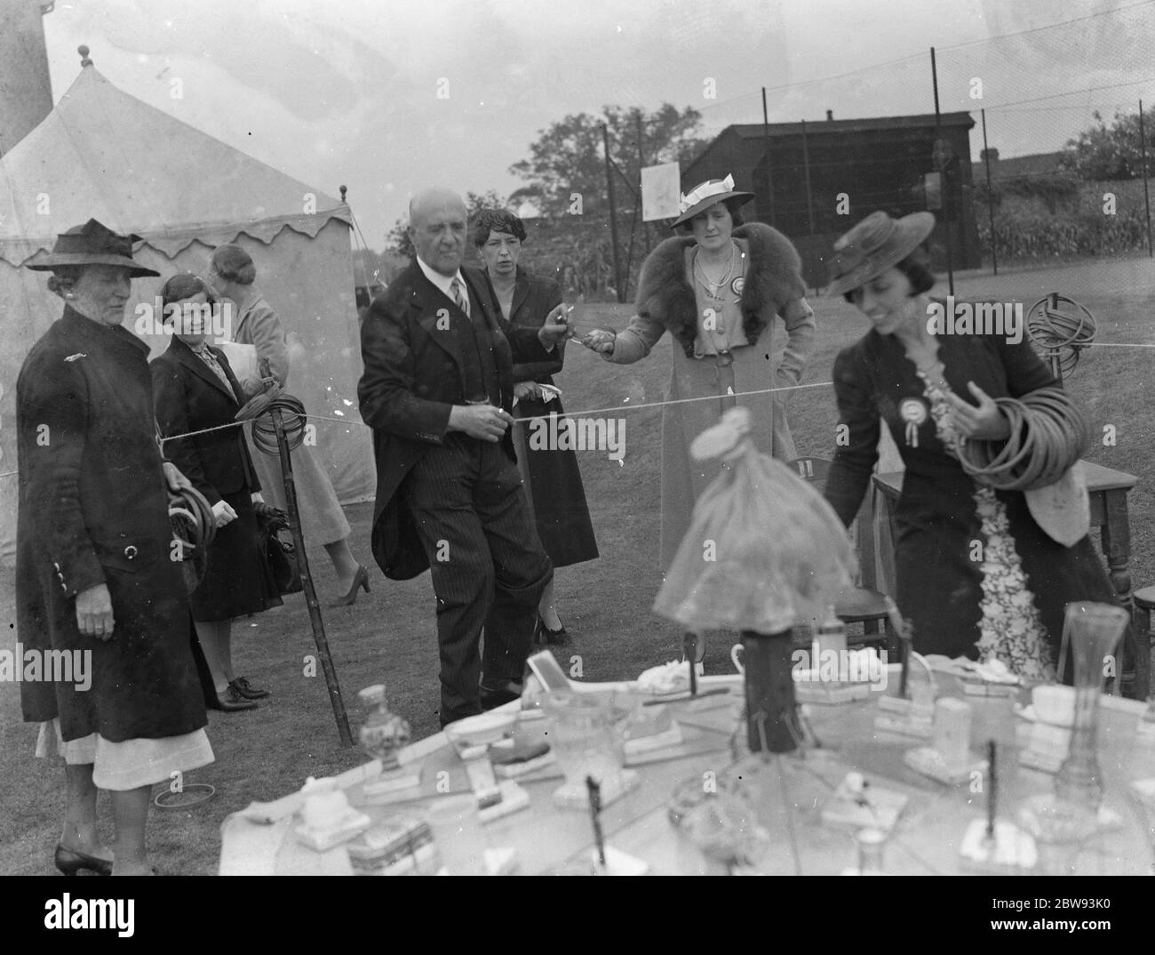 The charity Lifeboat fete in Scadbury , Kent . Sir Waldron Smithers and Mrs Marriot playing hoopla . 1939 Stock Photo