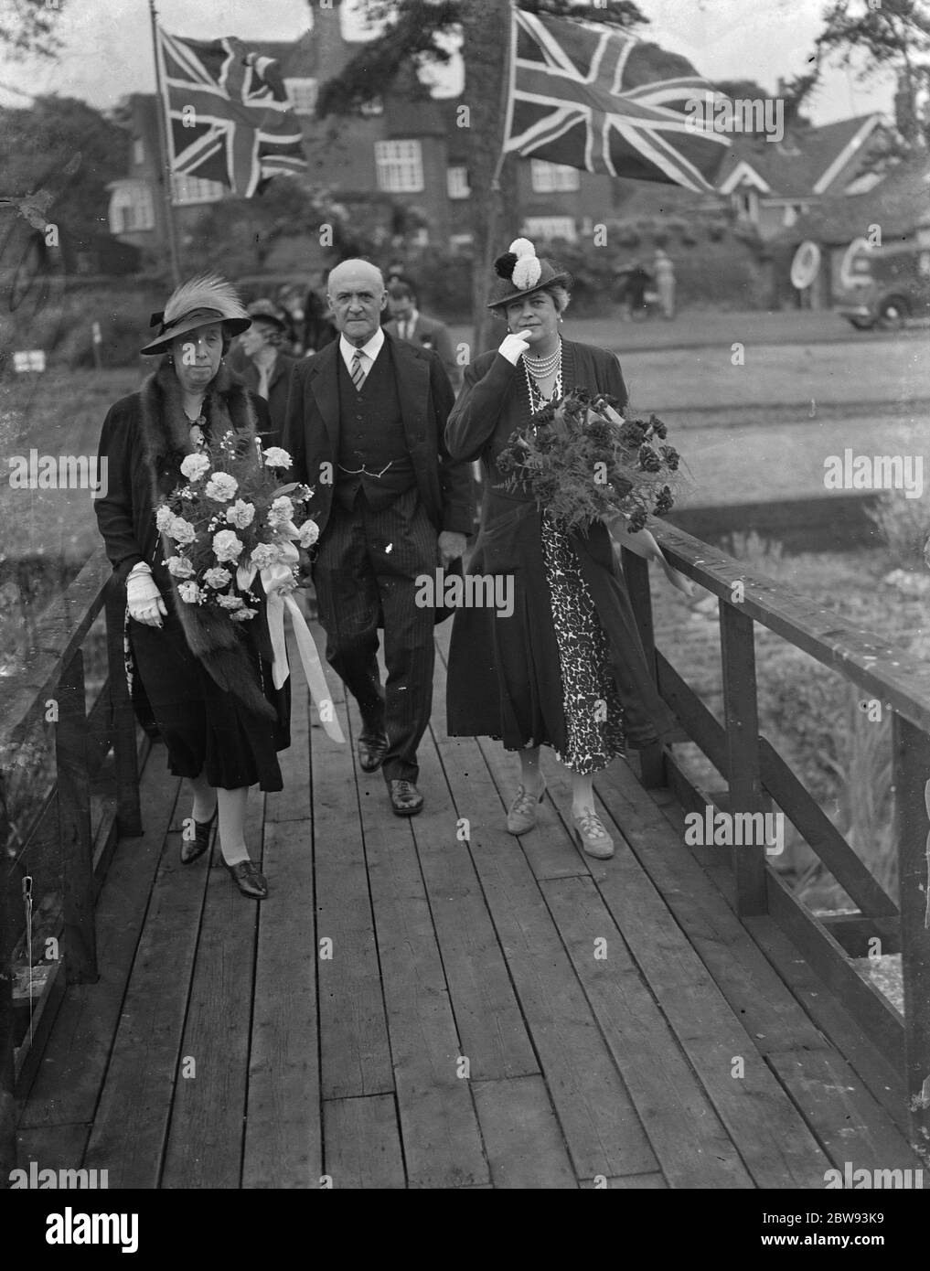 The charity Lifeboat fete in Scadbury , Kent . Lady Smithers , Sir Waldron Smithers and Mrs Marsham Townshends walking down a gangway . 1939 Stock Photo