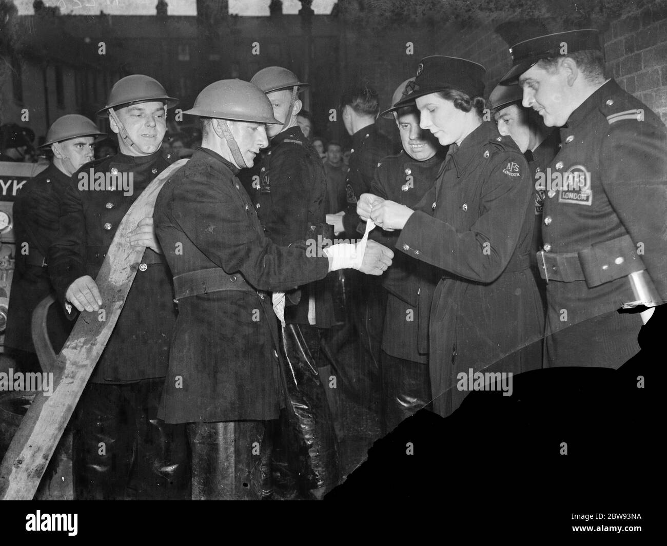A casualty is being bandaged at the Woolwich Auxillary Fire Service demonstration . 1939 Stock Photo