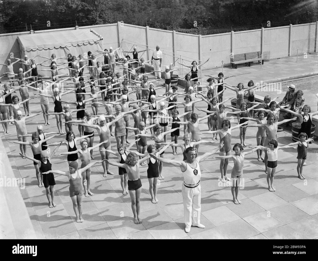 Children performing drills at the Swanscombe Baths in Kent . The instructor is Mr Bahalane . 1939 . Stock Photo