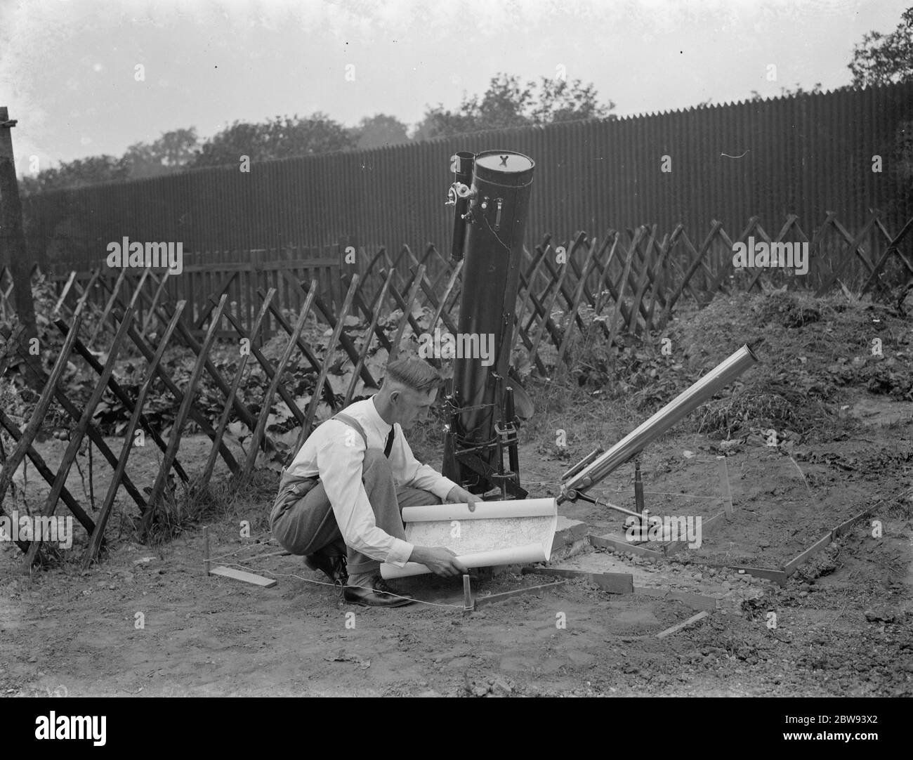 Dr Hugh Percival Wilkins PhD FRAS 1896 - 1960 was a British engineer by profession but most notably known as an amateur astronomer and particularly as a moon mapper . In his life he has created a number of moon maps , doing much of the observing from his home . Photo shows Mr Hugh Percy Wilkins at work in the garden of his home in Barnehurst , Kent . 1938 Stock Photo