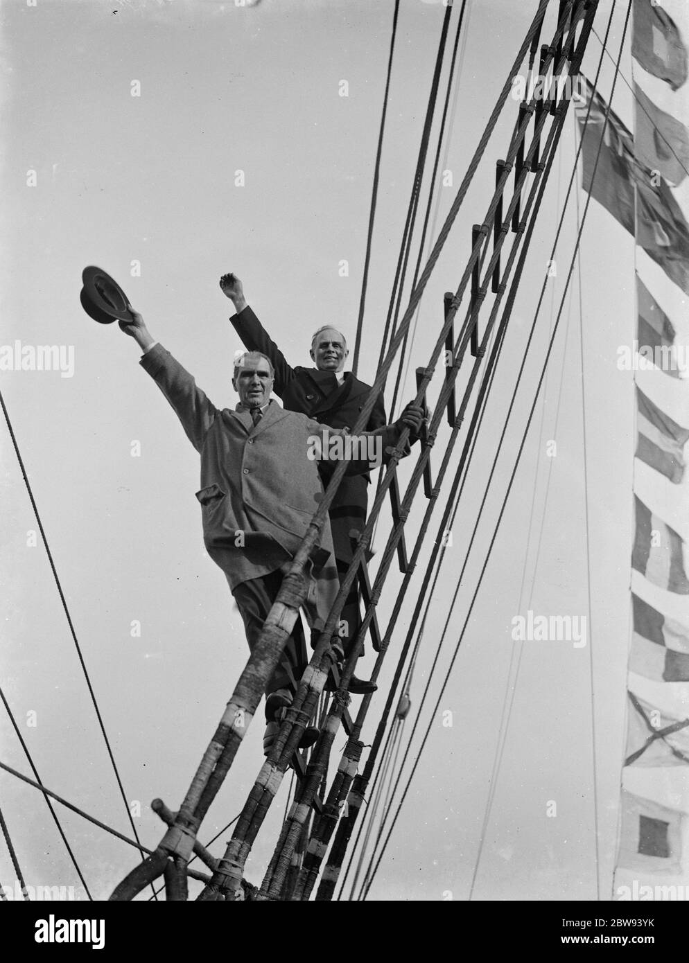 Old salts visit the Cutty Sark in Greenhithe , Kent . Captain R J Woodget and Captain A S Woodget wave from up the rigging . 1938 . Stock Photo