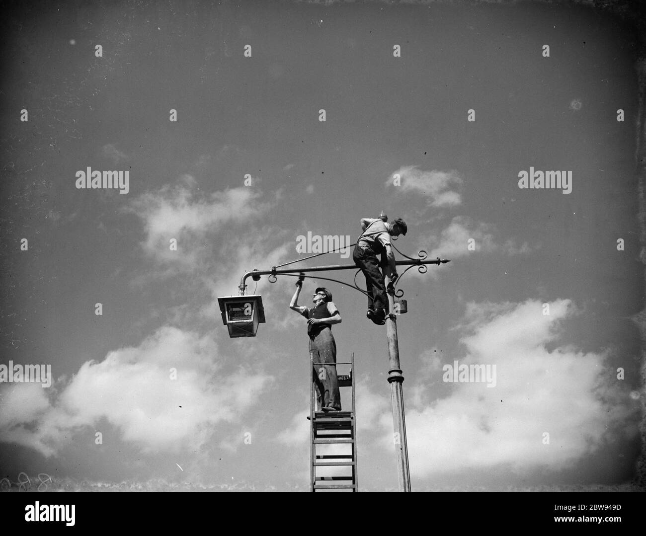 Men painting lamp a standard in Sidcup , Kent . 1938 Stock Photo