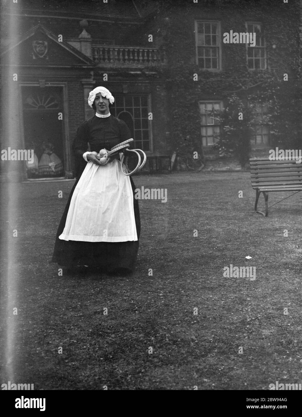 A woman in a servant 's period dress at Lullingstone Park near Eynsford , Kent . 1938 . Stock Photo