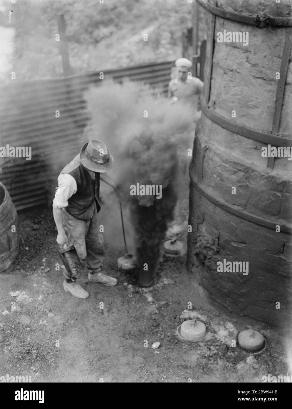 The Lime works in Dunton Green , Kent . Workers stoke the fires in the kilns . 1938 . Stock Photo