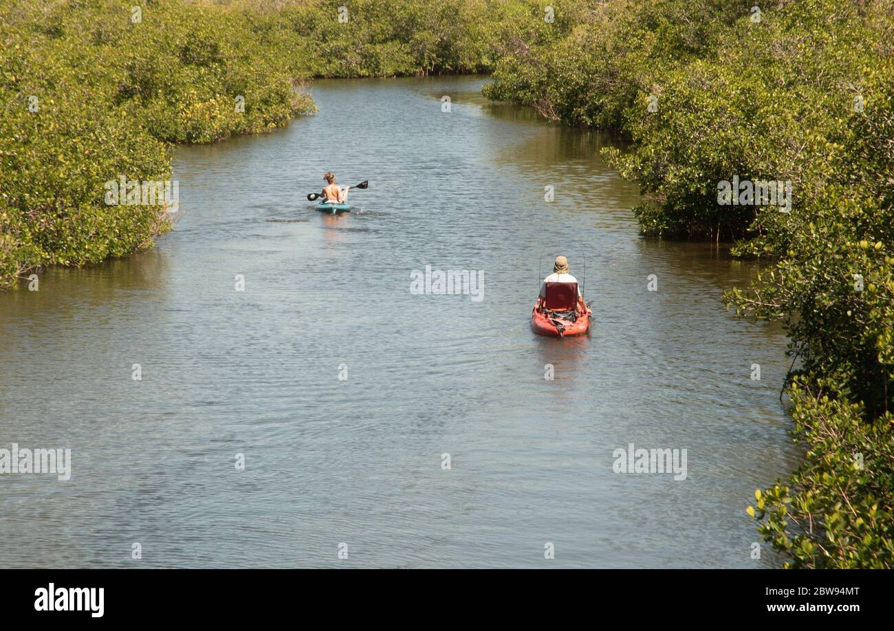 A couple of kayakers make their way down the Oyster Creek canal in