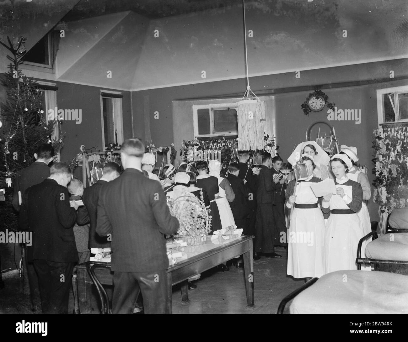 Choir boys and nurses sing Christmas carols to patients at Erith Hospital in London . 1936 Stock Photo