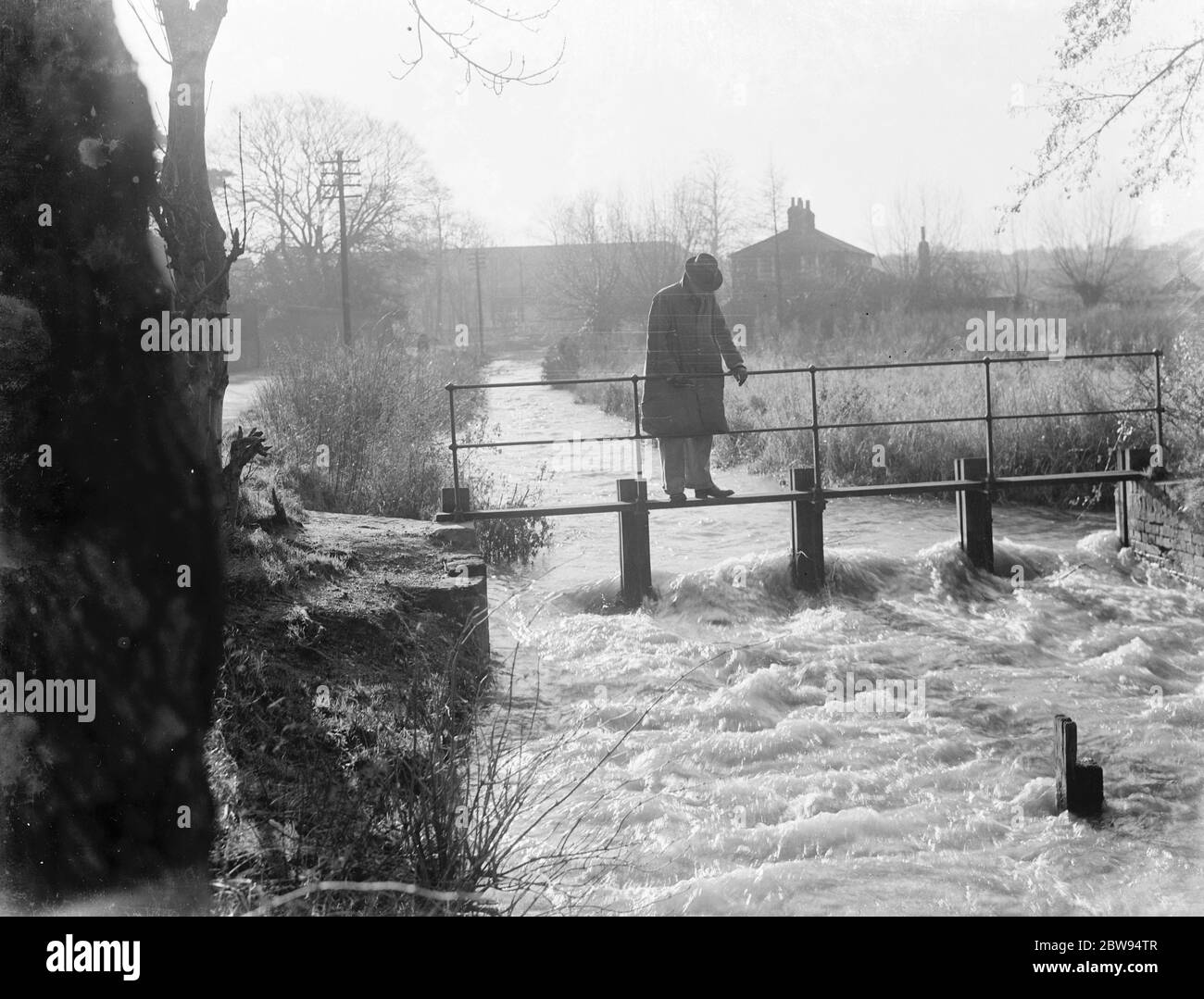 A foot bridge across the raging River Darenth . 1936 Stock Photo