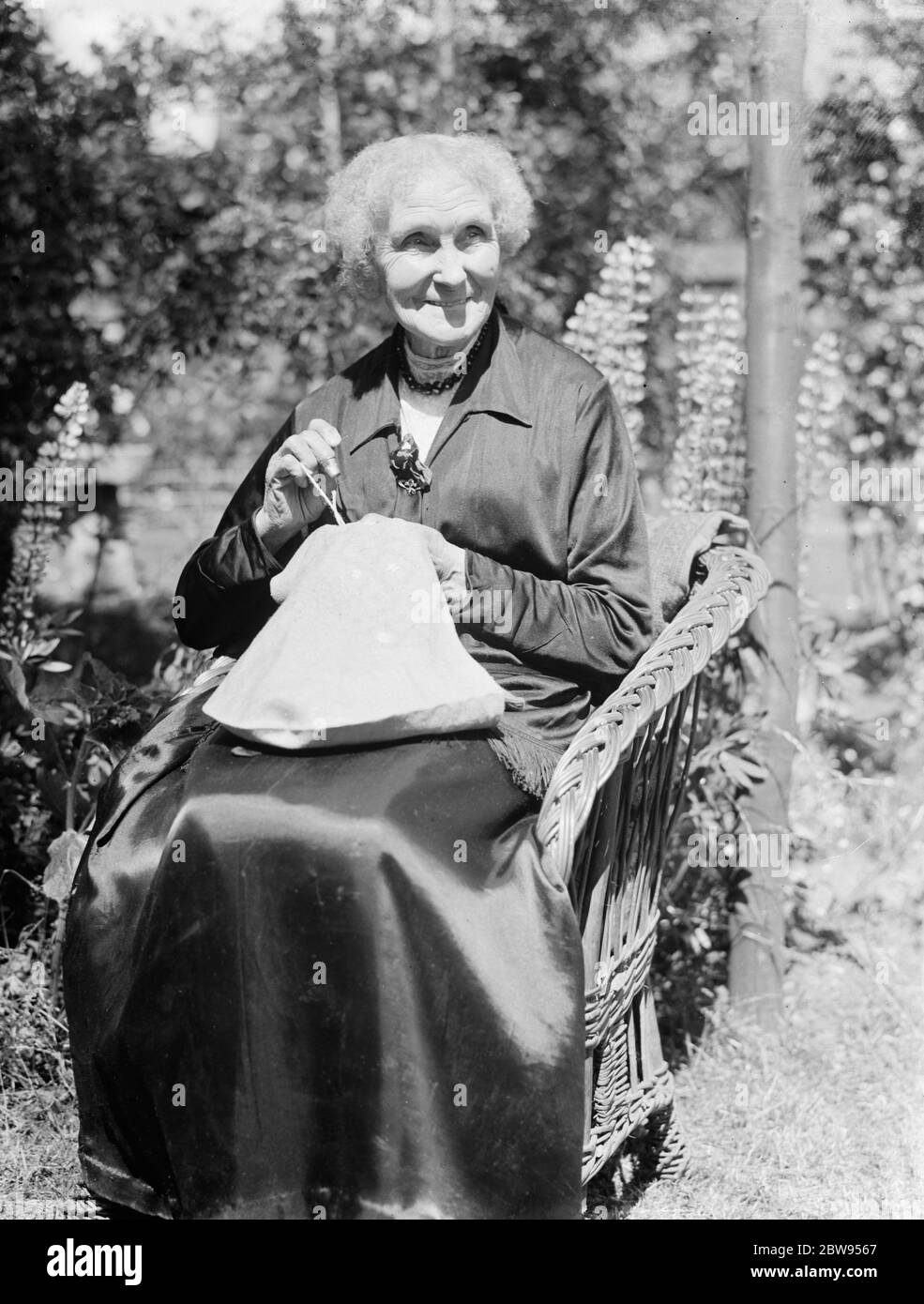 Granny Burton catching up on needle craft . 1936 Stock Photo