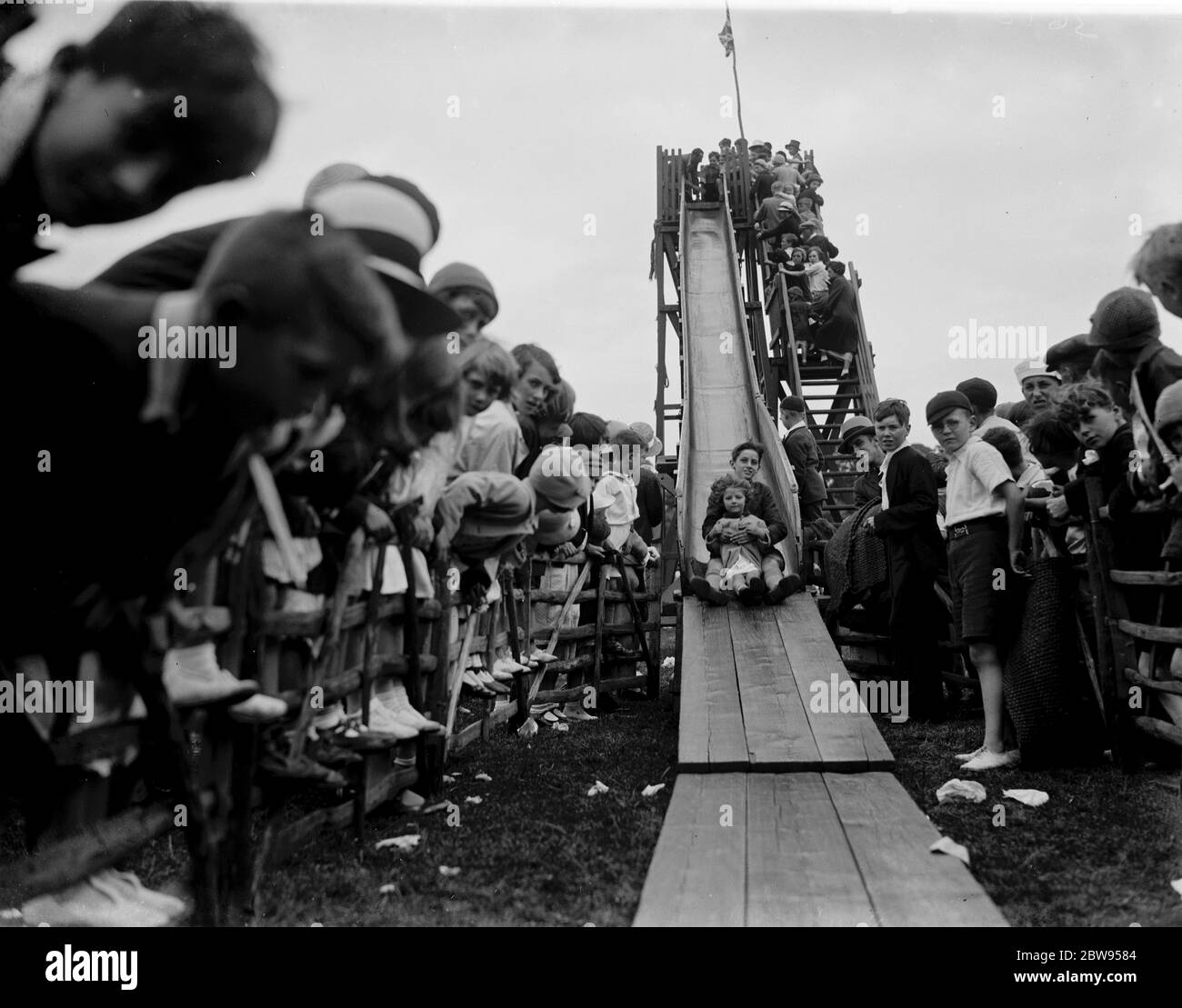Children on the helter skelter at the fairground for the Abbey Wood fete in London . 1936 Stock Photo