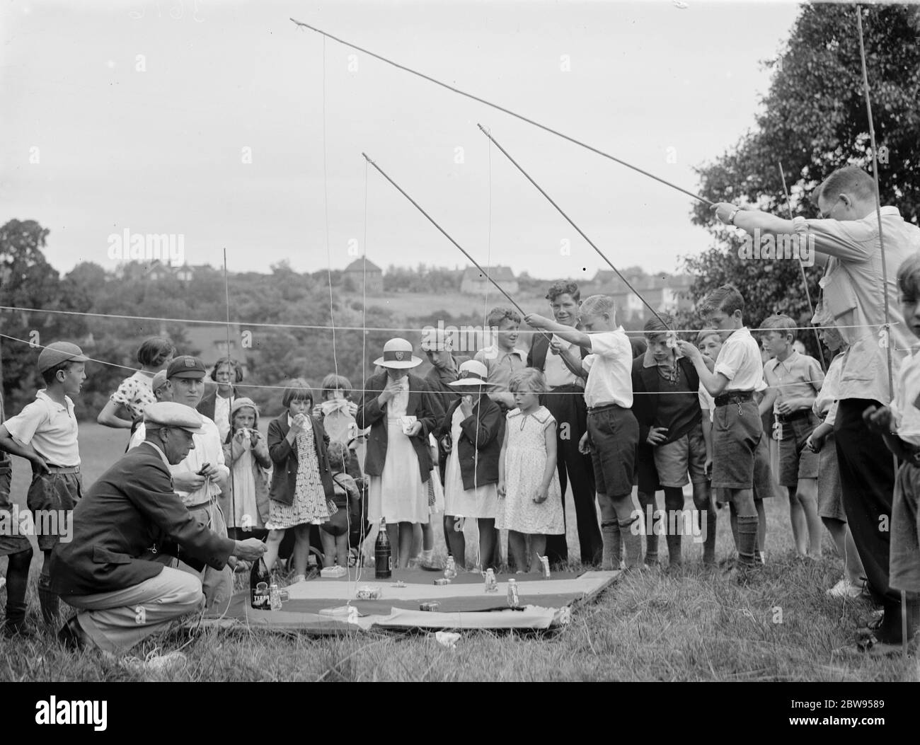 Longfield fete near Dartford , Kent . Children play traditional rod and