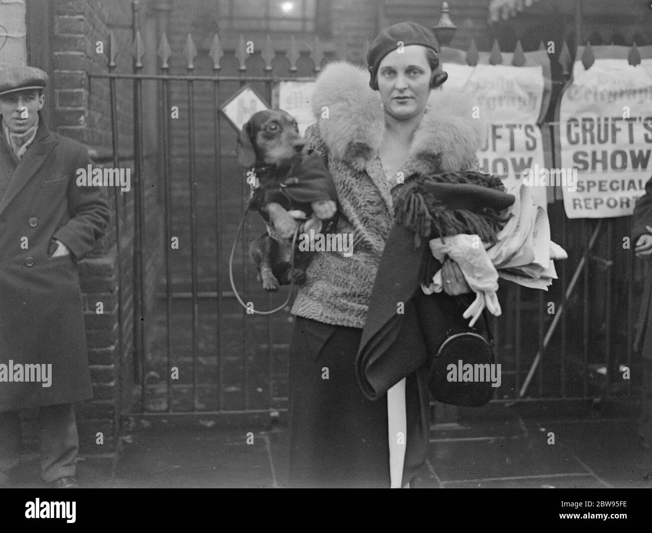 Cruft 's , the world 's largest Dog Show , opens . Cruft 's Dog Show , the largest in the world , at which more than 3400 entries of all kinds of dogs are being shown opened at the Agricultural Hall , Islington , London . Mrs Stanhope Joel , arriving with her wire haired Dachshund . 8 February 1933 Stock Photo