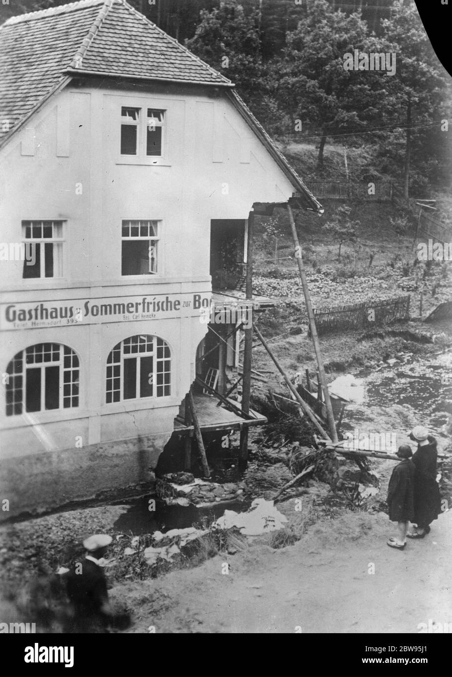 Cloud burst damage in Germany . Much damage was done by a cloud burst in Thuringia and other parts of Germany . The Bockmuhle Inn at the little village of Holzland destroyed in the cloud burst . 19 July 1932 Stock Photo
