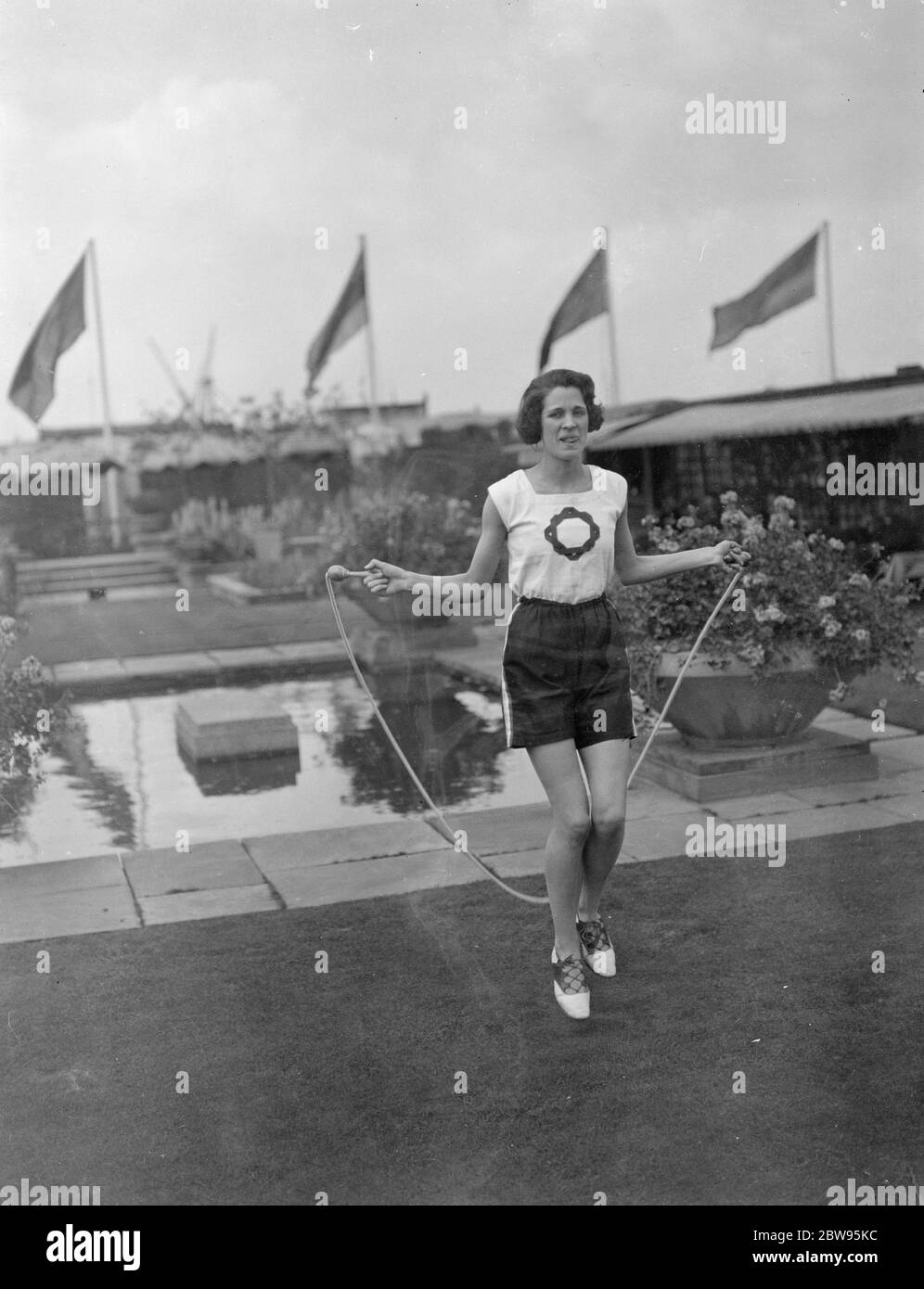 Olympic Games representative practices at lunch time on roof on store . Miss Violet Webb , who has been chosen to represent Great Britain in the hurdles at the Olympic Games at Los Angeles , USA practices every lunch hour on the roof of Selfridges store , where she is employed . Miss Violet Webb skipping during her roof lunch hour practice . 22 June 1932 Stock Photo