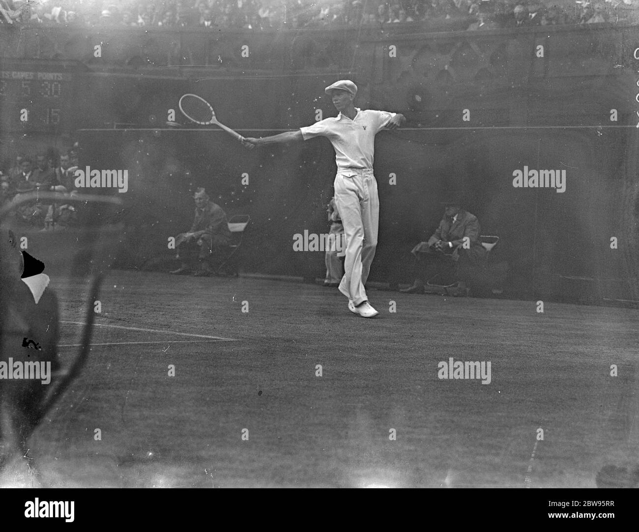 Vines defeats Crawford in men 's semi finals at Wimbledon . H E Vines of America defeated J Crawford of Australia 6-2 ; 6-1 ; 6-3 ; in the semi finals of the men 's singles in the Wimbledon tennis championships . Vines in play during the match . 30 June 1932 Stock Photo