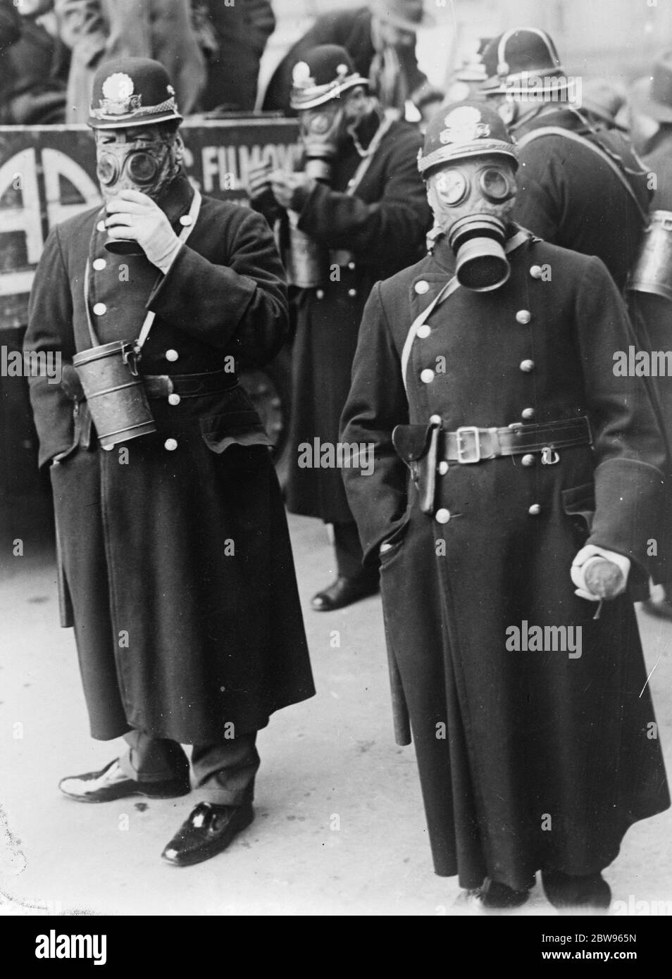 Prague police equipped with gas masks and bombs . The Prague police have been equipped with gas masks and tear gas bombs which henceforth will be part of their regular equipment . Prague policemen with bombs and wearing their gas masks . 23 January 1932 Stock Photo