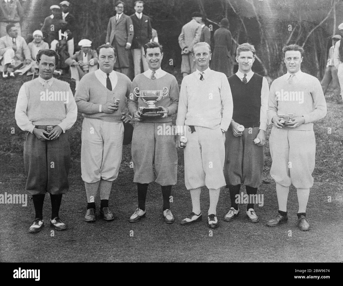 British golfers defeated in Bermuda . An American team of golfers defeated a British side in a tournament for the Castle Harbour Cup , at Bermuda . Left to right : Leonard Martin , Robert Lay , George Voight ( Captain with cup ) , Clive Llvord , George Hack and Paul Miller Jones , after their victory over the English side . 22 March 1932 Stock Photo