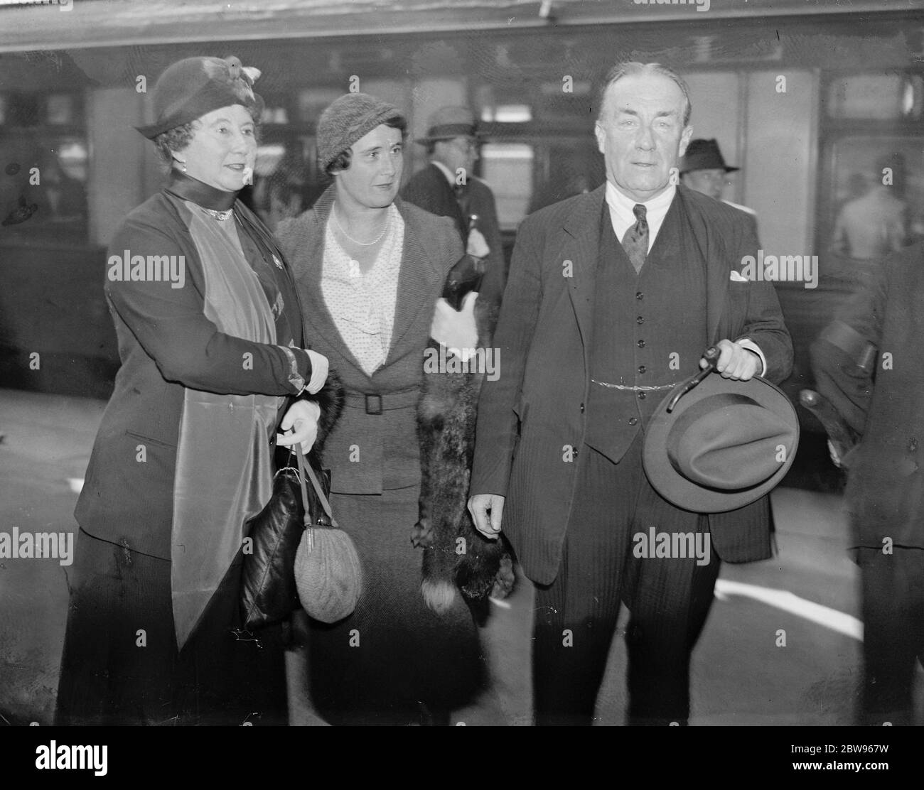 Mr Baldwin arrives home to meet cabinet crisis . Mr Stanley Baldwin arrived home after his holiday at Aix to meet the cabinet crisis . Attempts to patch up the differences with the Liberals have failed and it is expected that they will announce their decision to resign after the special cabinet meeting on Monday . Mr and Mrs Baldwin photographed at Victoria station , London on their arrival home . 25 September 1932 Stock Photo
