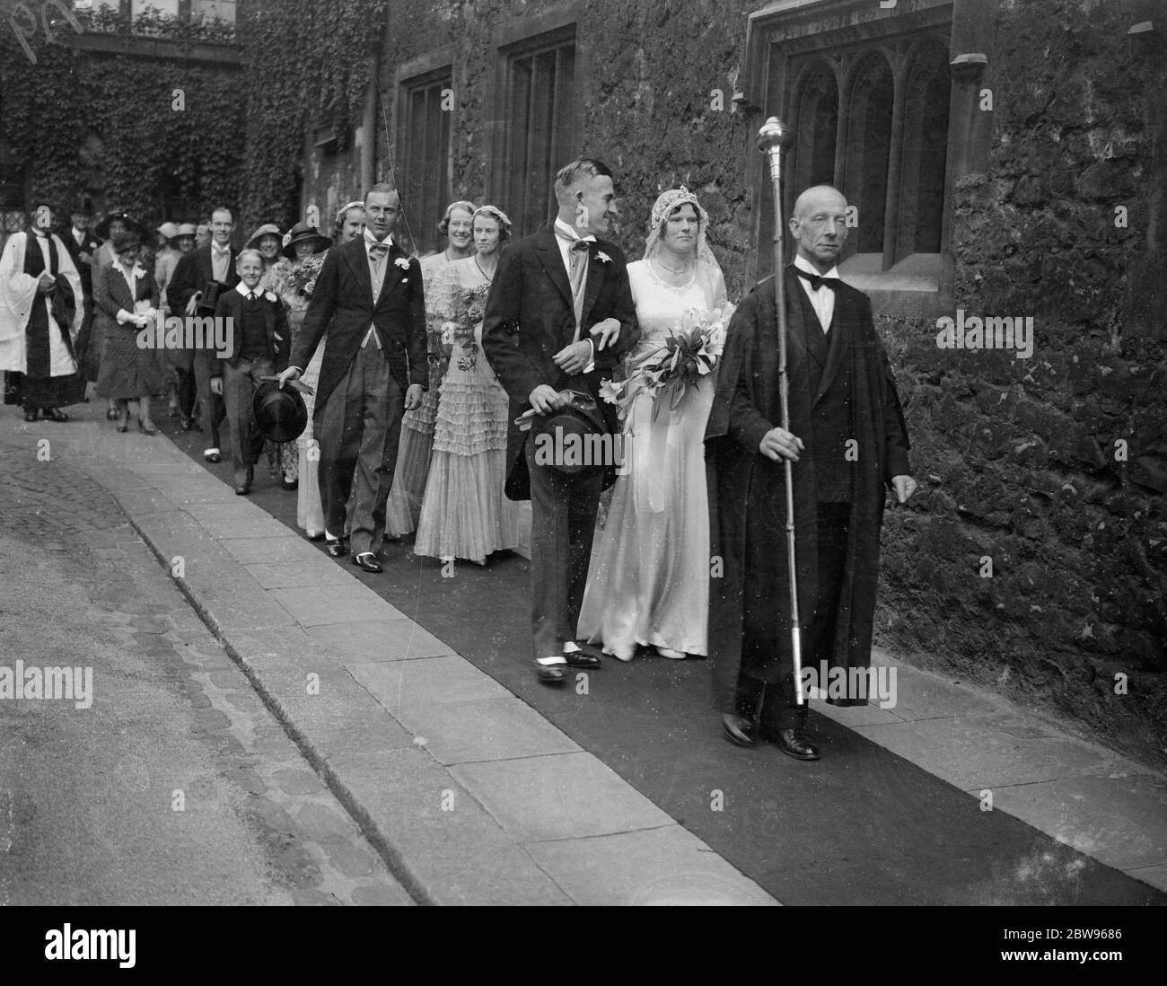 Westminster Abbey wedding for son of Archdeacon of Westminster . The wedding of Dr Noel Storr , son of Canon Vernon Storr , Archdeacon of Westminster , to Miss Joyce Taynton took place in the beautiful Henry VII Chapel in Westminster Abbey . After the wedding the bridal procession walked through the cloisters to the Canon 's residence in Deans Yard . The bridal procession through the cloisters . 1 September 1932 Stock Photo