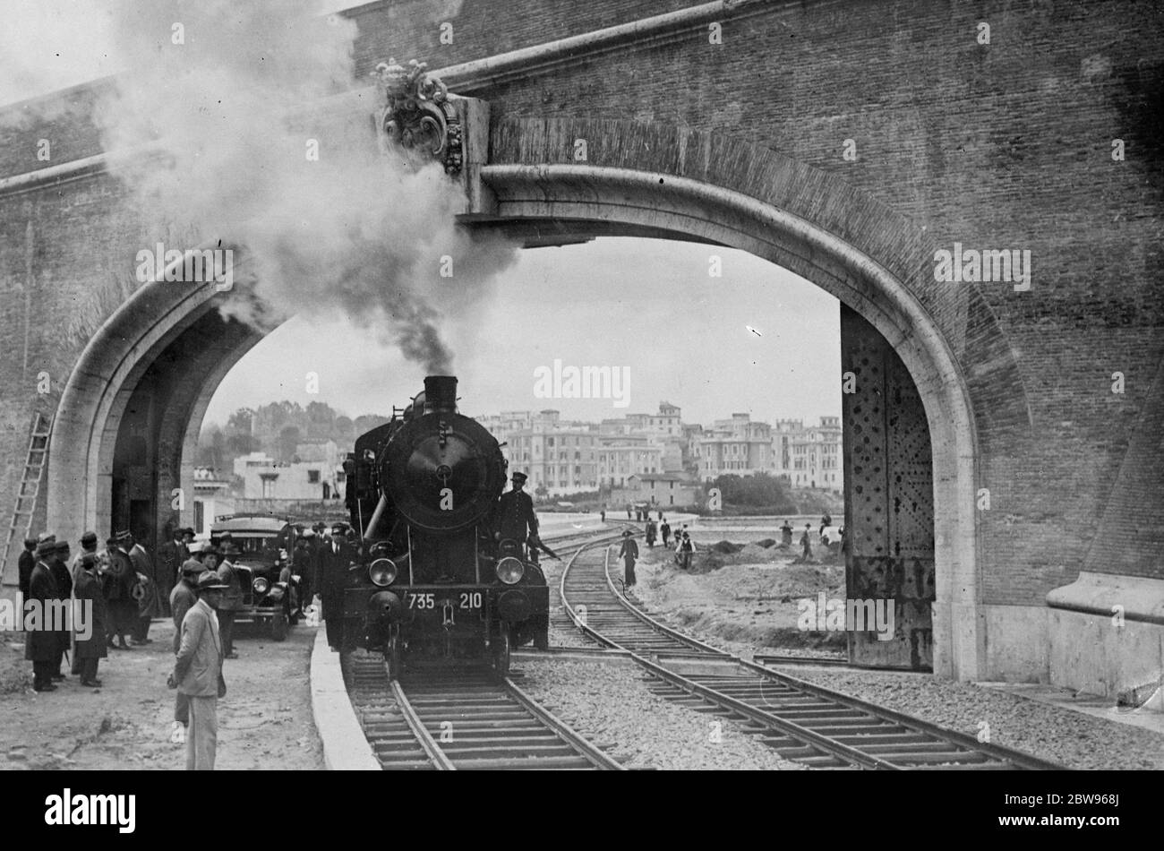 The first railway train arrives in the Vatican City . History was made when the first railway train steamed into the new Vatican Station , within the shadow of St Peters , Rome . The first train entering the new Vatican Station . 5 April 1932 Stock Photo
