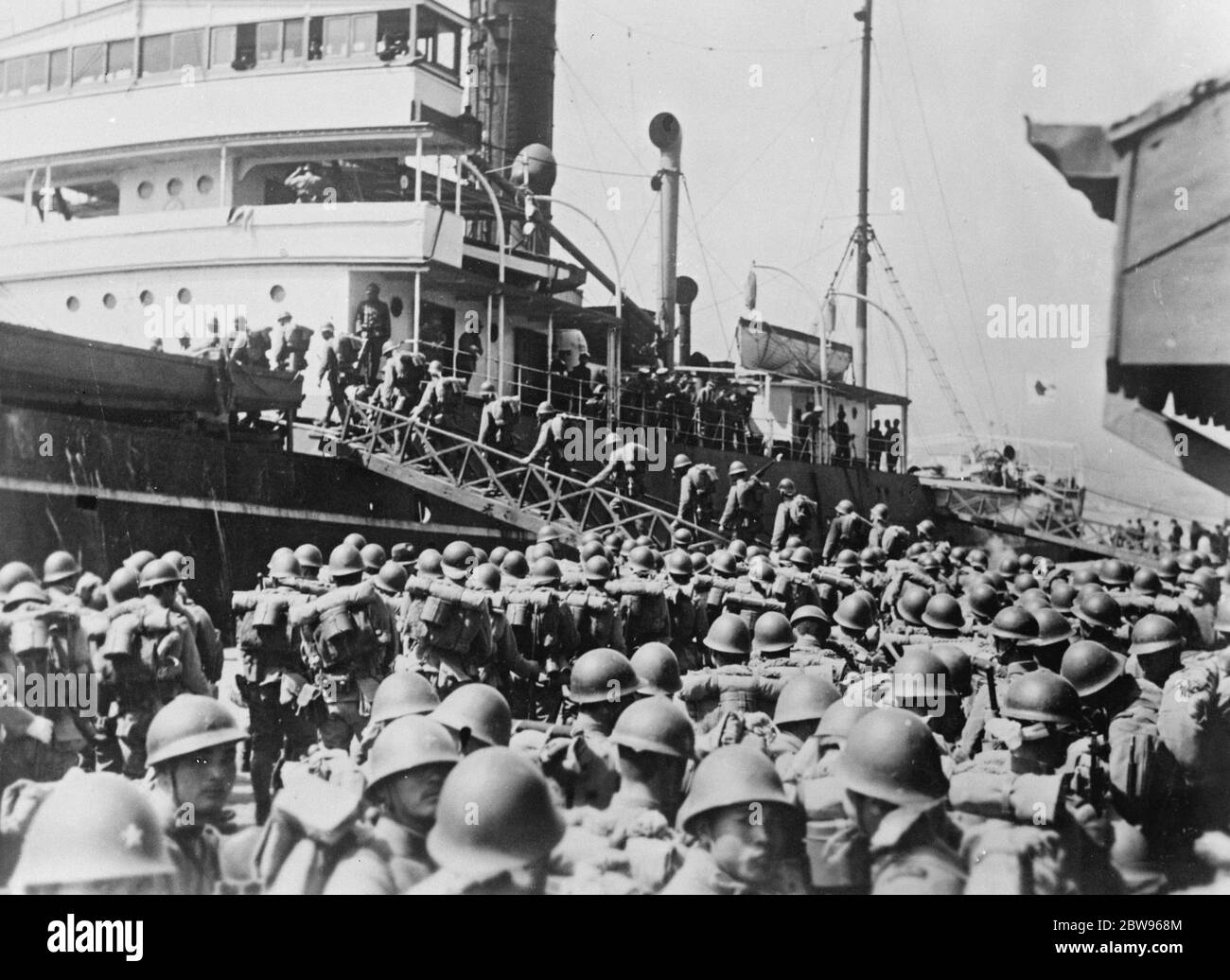 Japan withdraws its troops from China . The Japanese army is gradually evacuating the territory occupied in the Shanghai district during the recent hostilities . A picture just received in London showing a battalion of Japanese troops embarking on a transport at Shanghai on their return home . 23 April 1932 . Stock Photo