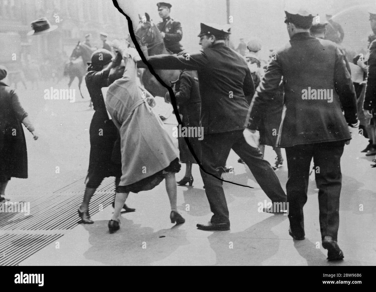 Women reds fight police in communist demonstration in New York . After marching in two lines in opposite directions around the City Hall , New York , demanding to see Mayor Walker , Communists demonstrated outside the building and police were compelled to charge them before they would disperse . Police fighting with women communists outside the city Hall , New York . 29 April 1932 Stock Photo
