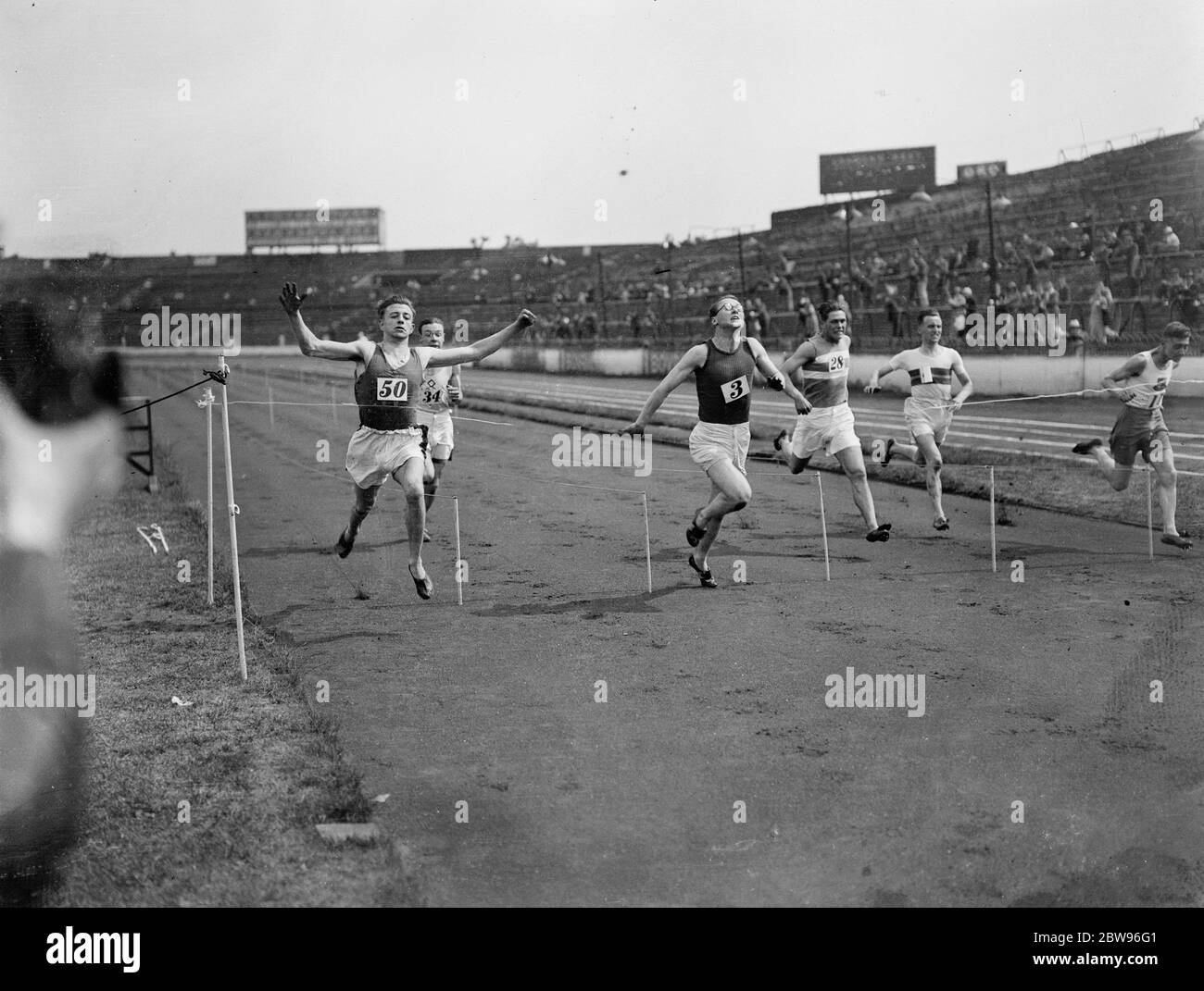 A spectacular finish at junior amateur athietic association sports . J S K Glover , of Wallasey Athletic Club , ( No 50 ) extreme left , winning the 100 yards final , in a spectacular finish at the Junior Amateur Athletic Association Sports , at Stamford Bridge . 25 June 1932 Stock Photo